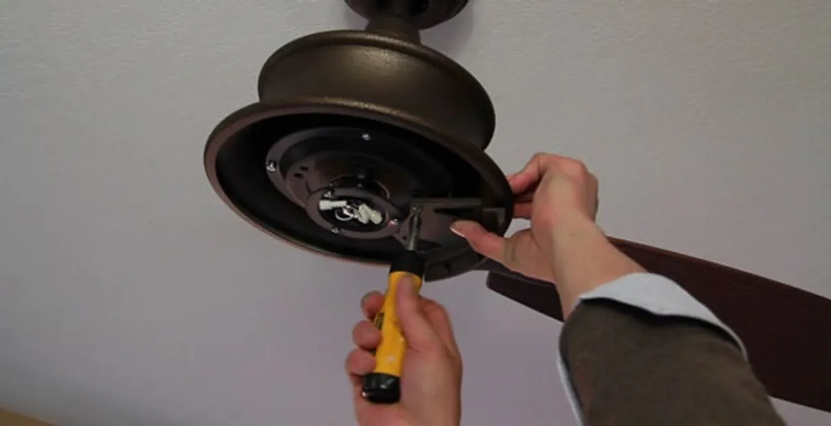 Electrician installing ceiling fan mounting bracket and fixture in Bakersfield, CA