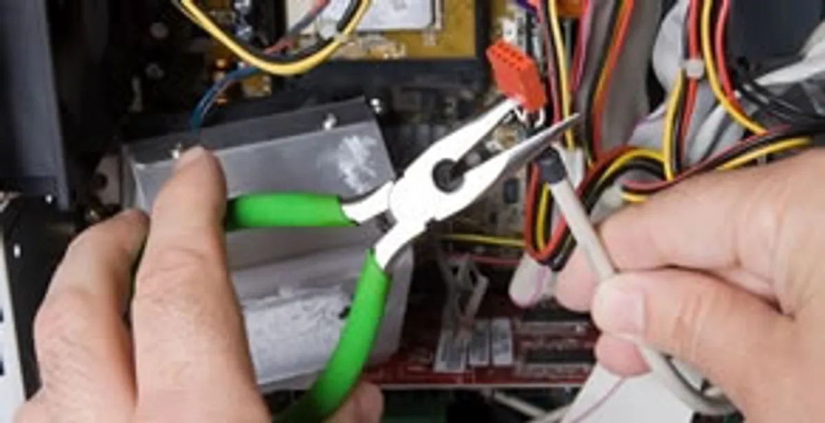 Licensed electrical contractor performing electrical repair with tools in Mc Farland, CA